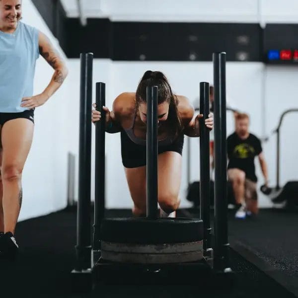 Woman pushing sled forward
